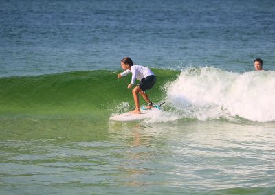 Kid riding wave at RideOn Surf School
