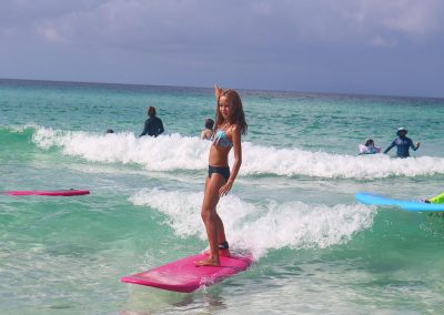 Girl learning to surf at RideOn Surf School