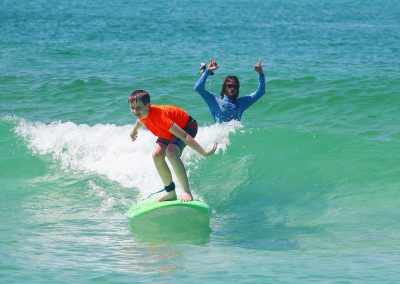 Boy surfing a wave at Billabong RideOn Surf School Camp