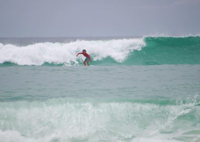 Boy riding wave at RideOn Surf School